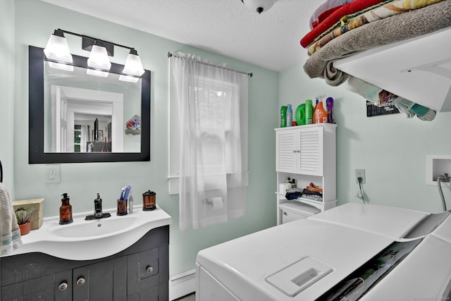 79 Ledgewood Dr, North Branford, CT 06471 - laundry room featuring washer and dryer, a textured ceiling, and baseboard heating