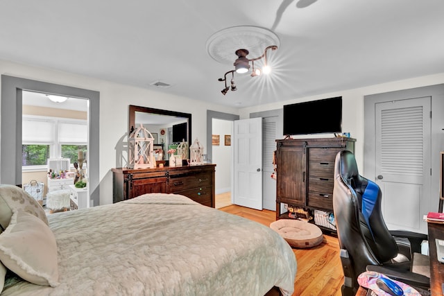 79 Ledgewood Dr, North Branford, CT 06471 - bedroom with light wood finished floors and a chandelier