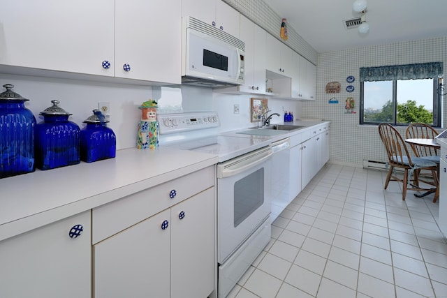 3200 Park Ave Unit 6A2, Bridgeport, CT 06604 - kitchen with white appliances, light countertops, light tile patterned flooring, and white cabinets