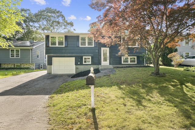 32 Cullen Ave, West Haven, CT 06516 - bi-level home with driveway, a front lawn, and an attached garage