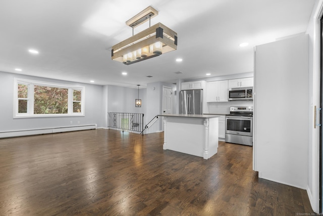 32 Cullen Ave, West Haven, CT 06516 - kitchen with appliances with stainless steel finishes, open floor plan, recessed lighting, white cabinetry, and dark wood-style flooring
