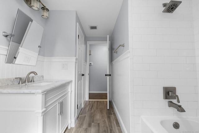 32 Cullen Ave, West Haven, CT 06516 - bathroom featuring vanity, a wainscoted wall, wood finished floors, and tub / shower combination