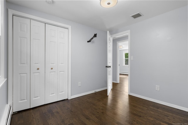 32 Cullen Ave, West Haven, CT 06516 - unfurnished bedroom featuring a baseboard heating unit, wood finished floors, and a closet