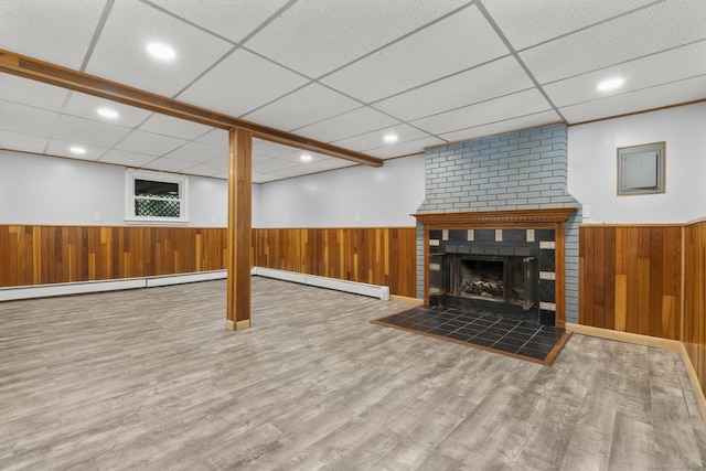 32 Cullen Ave, West Haven, CT 06516 - finished below grade area featuring a baseboard heating unit, a drop ceiling, wainscoting, wood finished floors, and wood walls