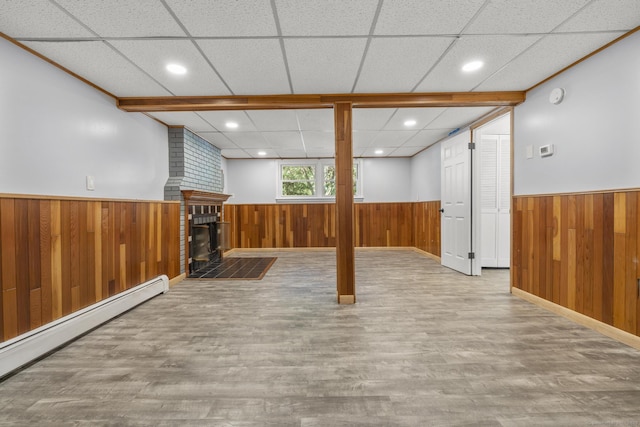 32 Cullen Ave, West Haven, CT 06516 - below grade area featuring wainscoting, baseboard heating, wood walls, wood finished floors, and a drop ceiling