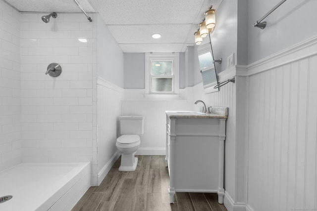 32 Cullen Ave, West Haven, CT 06516 - full bathroom with a wainscoted wall, vanity, tiled shower, and wood finished floors