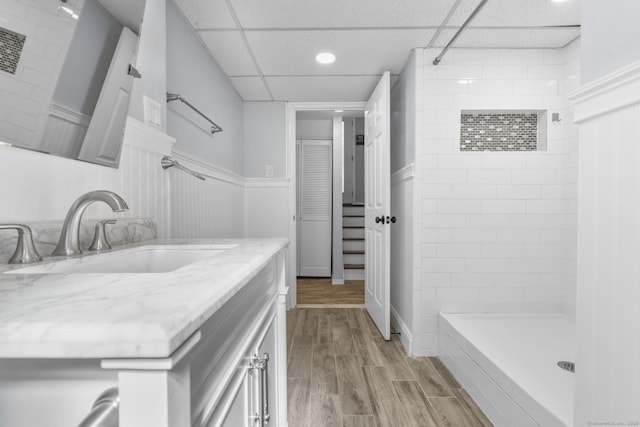 32 Cullen Ave, West Haven, CT 06516 - full bath featuring vanity, a tile shower, wainscoting, wood finished floors, and a drop ceiling