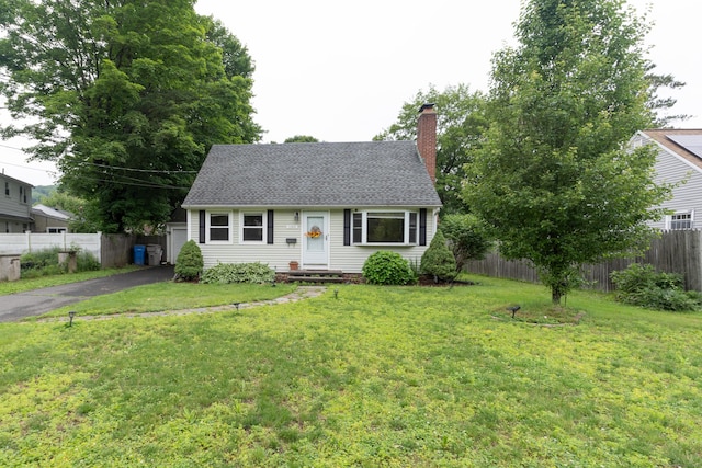 180 Lake Ave, Bristol, CT 06010 - cape cod home featuring a chimney, roof with shingles, asphalt driveway, and a garage