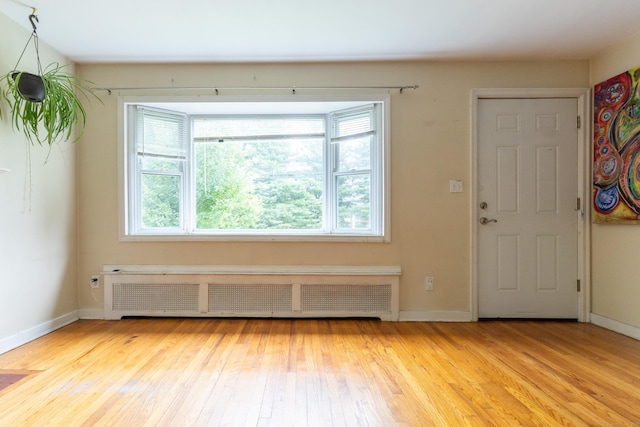 180 Lake Ave, Bristol, CT 06010 - entrance foyer featuring radiator heating unit, healthy amount of natural light, and light wood-style flooring