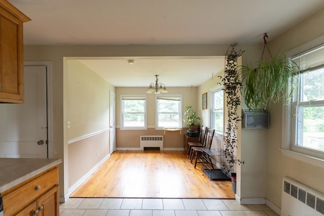 180 Lake Ave, Bristol, CT 06010 - dining area with radiator heating unit, healthy amount of natural light, and a chandelier