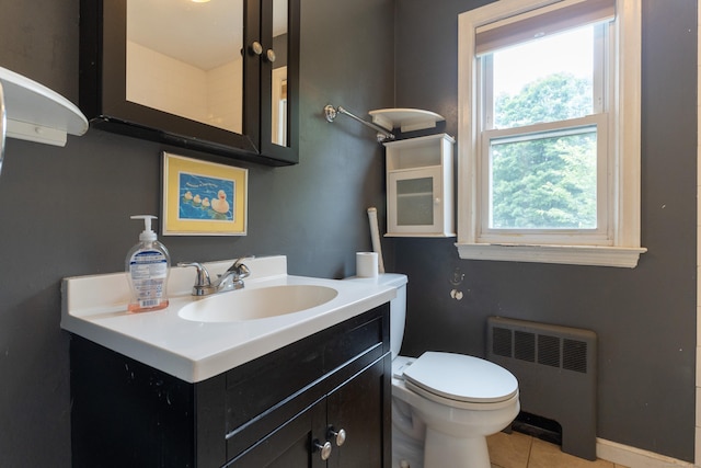 180 Lake Ave, Bristol, CT 06010 - half bathroom with radiator heating unit, vanity, and tile patterned floors