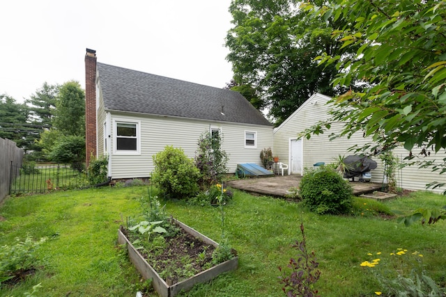 180 Lake Ave, Bristol, CT 06010 - back of house featuring a chimney, a patio area, a vegetable garden, and a shingled roof