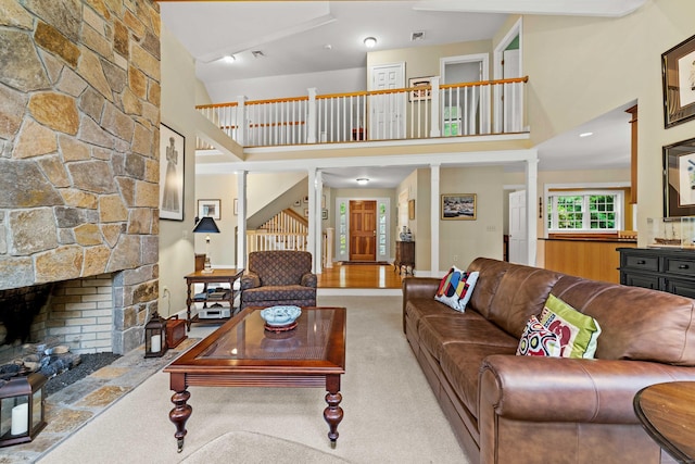 95 Shailer Pond Rd, Deep River, CT 06417 - carpeted living area featuring a high ceiling, decorative columns, and a fireplace