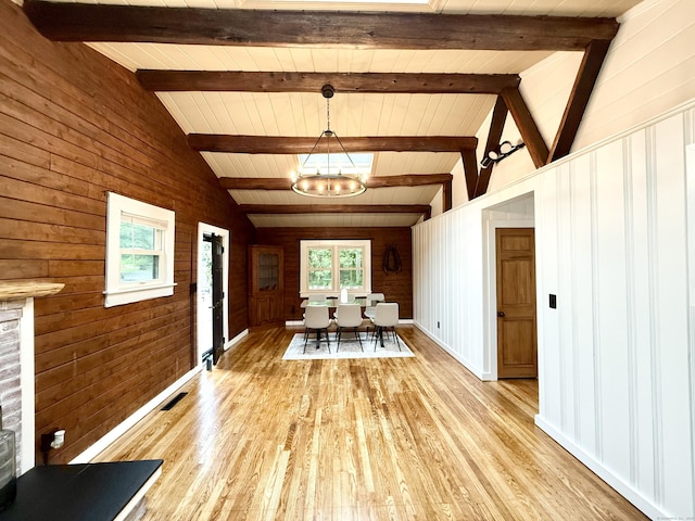 3951 S St, Coventry, CT 06238 - dining room with a chandelier, light wood-style floors, wood walls, and wooden ceiling