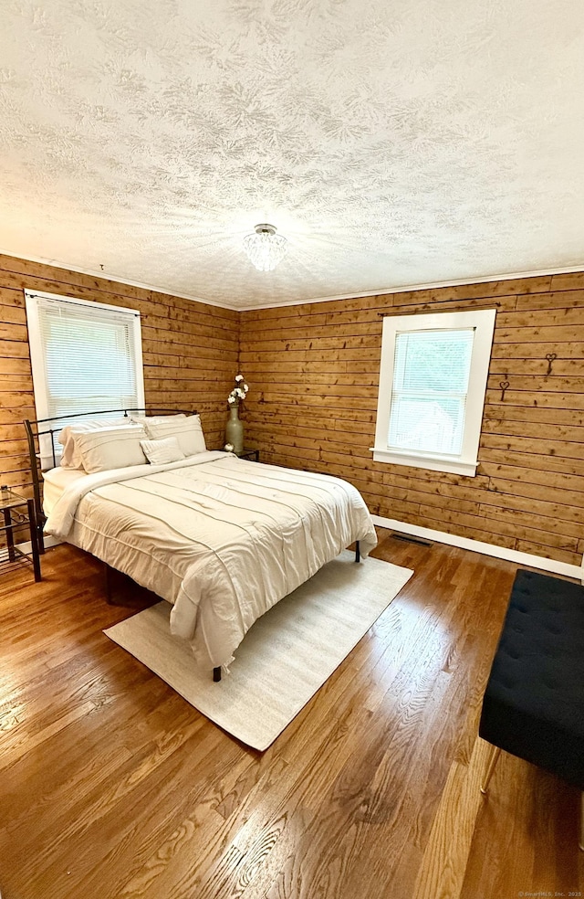 3951 S St, Coventry, CT 06238 - bedroom featuring a textured ceiling, wood finished floors, and wood walls