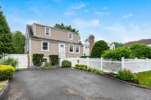 10 Sable St, Norwalk, CT 06854 - dutch colonial with a chimney, roof with shingles, and a gate
