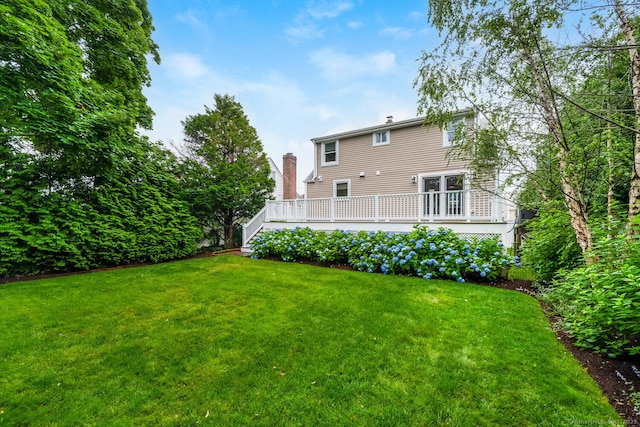 10 Sable St, Norwalk, CT 06854 - back of house featuring a yard, a wooden deck, and a chimney
