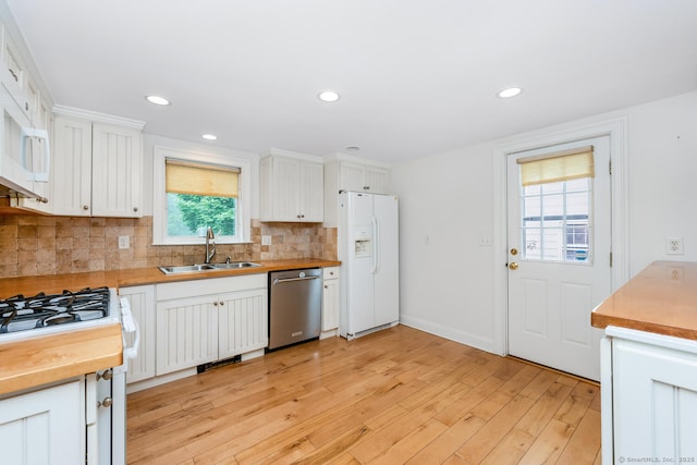 10 Sable St, Norwalk, CT 06854 - kitchen featuring white appliances, wooden counters, backsplash, light wood-style flooring, and white cabinetry