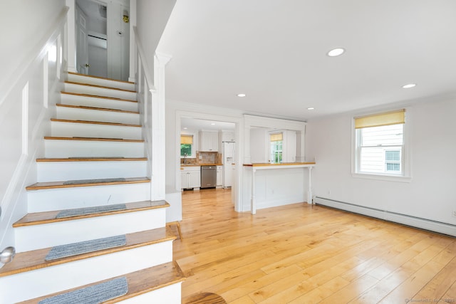 10 Sable St, Norwalk, CT 06854 - stairway featuring a baseboard radiator, hardwood / wood-style flooring, and recessed lighting
