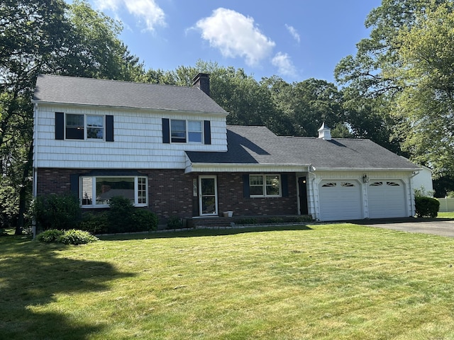 25 Tanglewood Ln, Naugatuck, CT 06770 - view of front of property featuring a garage, asphalt driveway, a chimney, brick siding, and a front lawn