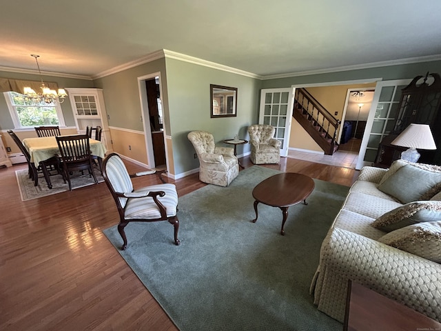 25 Tanglewood Ln, Naugatuck, CT 06770 - living room featuring a chandelier, wood finished floors, stairs, and crown molding