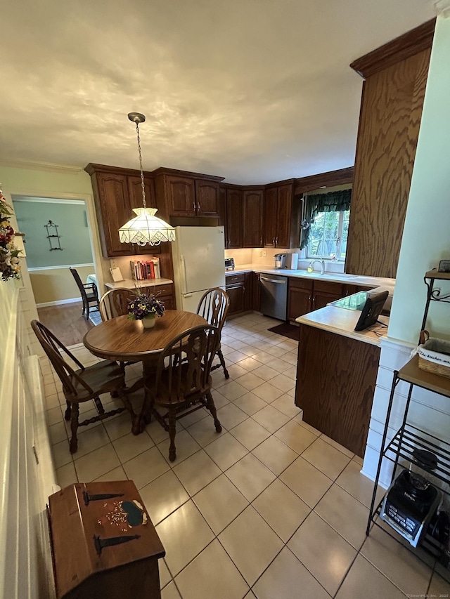 25 Tanglewood Ln, Naugatuck, CT 06770 - kitchen with freestanding refrigerator, stainless steel dishwasher, light tile patterned floors, dark brown cabinets, and a peninsula