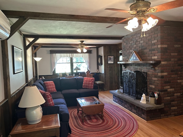 25 Tanglewood Ln, Naugatuck, CT 06770 - living area featuring ceiling fan, wood finished floors, beamed ceiling, a brick fireplace, and a wall unit AC