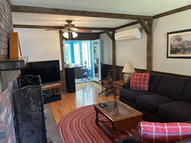 25 Tanglewood Ln, Naugatuck, CT 06770 - living area featuring an AC wall unit, wood finished floors, a ceiling fan, beamed ceiling, and wainscoting