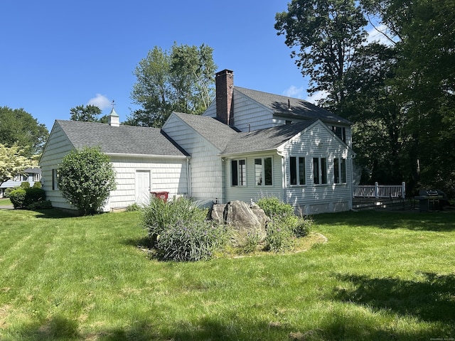 25 Tanglewood Ln, Naugatuck, CT 06770 - back of house with a yard, a chimney, roof with shingles, and a wooden deck