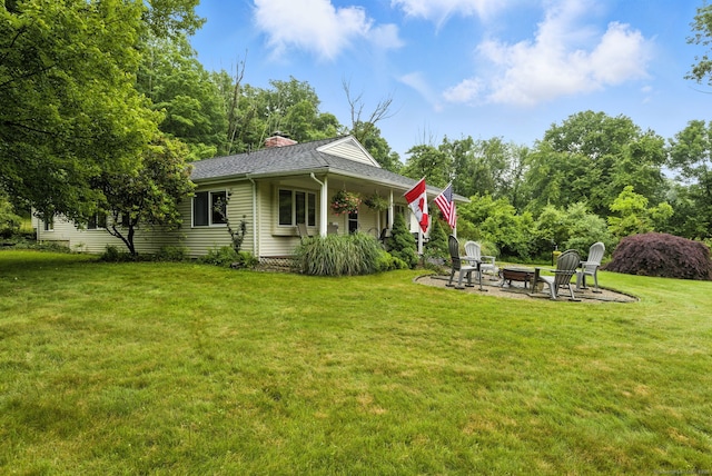 480 Wall St, Hebron, CT 06248 - rear view of house featuring an outdoor fire pit, a yard, a chimney, a patio, and a shingled roof