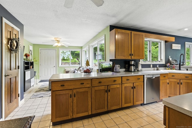 480 Wall St, Hebron, CT 06248 - kitchen featuring a ceiling fan, dishwasher, light tile patterned floors, light countertops, and a textured ceiling