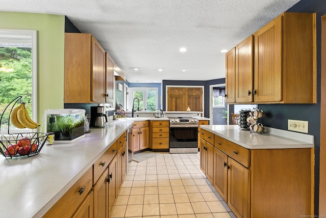 480 Wall St, Hebron, CT 06248 - kitchen with appliances with stainless steel finishes, light countertops, recessed lighting, light tile patterned floors, and a textured ceiling