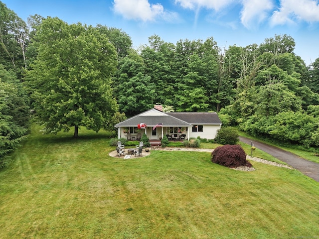 480 Wall St, Hebron, CT 06248 - view of front of home with a front yard, a chimney, and a forest view