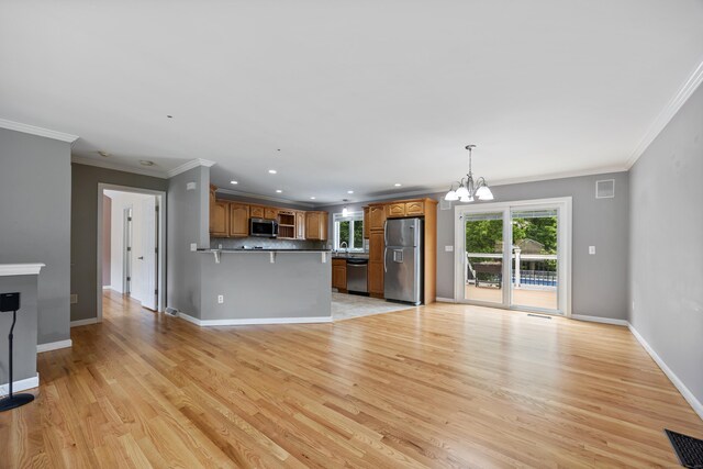123 Sperry Ln, Meriden, CT 06451 - unfurnished living room with a chandelier, light wood-type flooring, crown molding, and recessed lighting