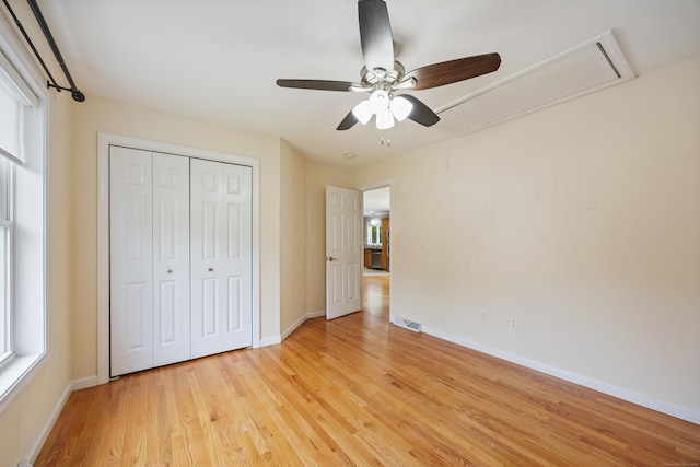 123 Sperry Ln, Meriden, CT 06451 - unfurnished bedroom featuring attic access, light wood finished floors, a closet, and ceiling fan