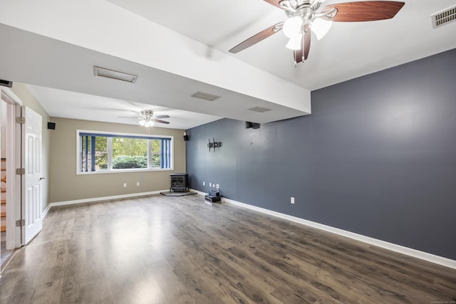 123 Sperry Ln, Meriden, CT 06451 - spare room with a wood stove, ceiling fan, wood finished floors, and stairway