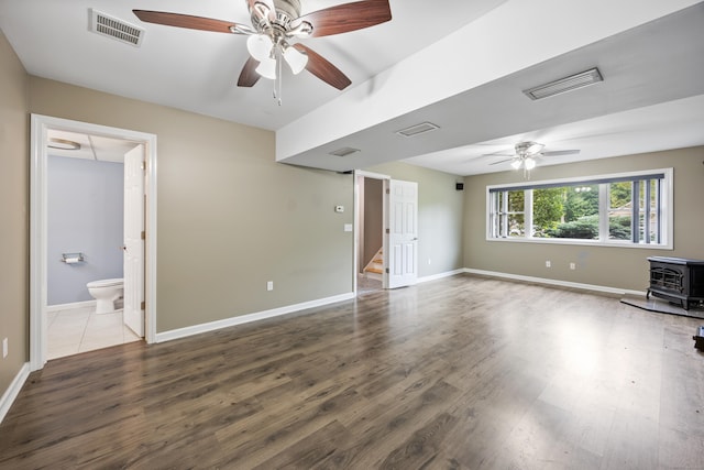 123 Sperry Ln, Meriden, CT 06451 - unfurnished living room with a wood stove, a ceiling fan, and wood finished floors