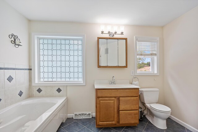 123 Sperry Ln, Meriden, CT 06451 - bathroom with a garden tub, vanity, and tile patterned floors