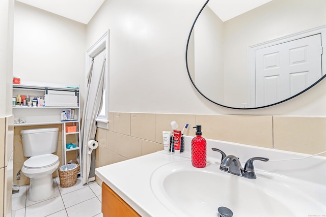 190 Whitney Ave, Bridgeport, CT 06606 - bathroom featuring tile walls, tile patterned flooring, vanity, and a wainscoted wall
