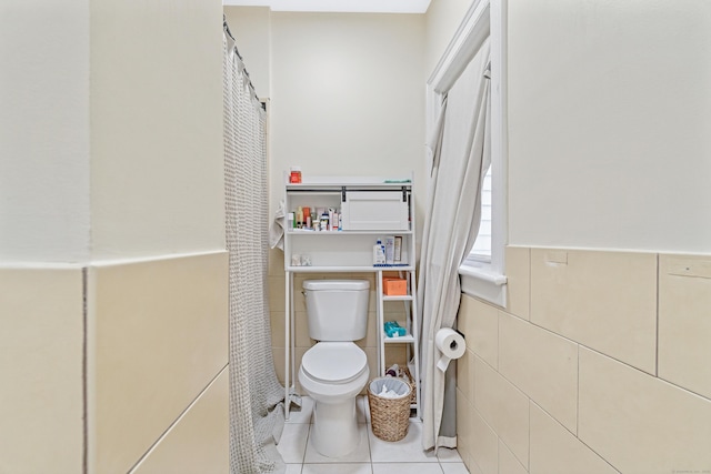 190 Whitney Ave, Bridgeport, CT 06606 - bathroom featuring tile walls, tile patterned flooring, a wainscoted wall, and curtained shower