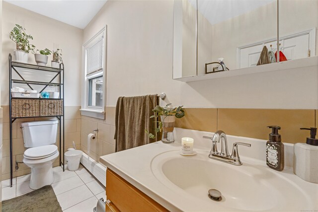 190 Whitney Ave, Bridgeport, CT 06606 - bathroom featuring tile patterned flooring, vanity, tile walls, and a wainscoted wall