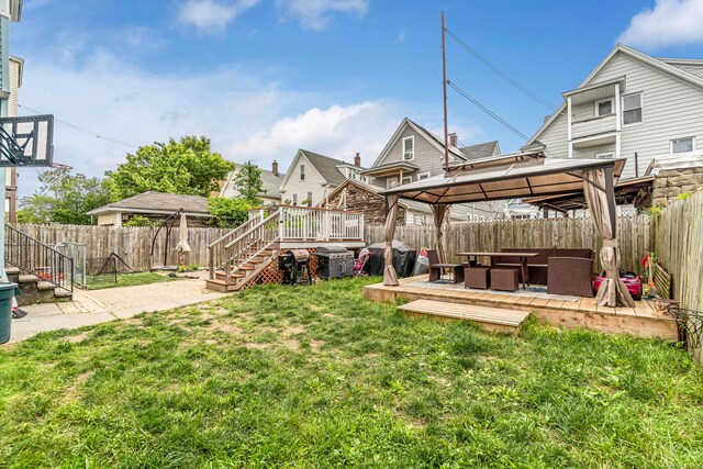 190 Whitney Ave, Bridgeport, CT 06606 - fenced backyard featuring a gazebo, a wooden deck, stairs, and an outdoor hangout area