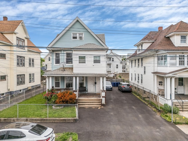 190 Whitney Ave, Bridgeport, CT 06606 - view of front of house featuring a porch, roof with shingles, a residential view, and asphalt driveway