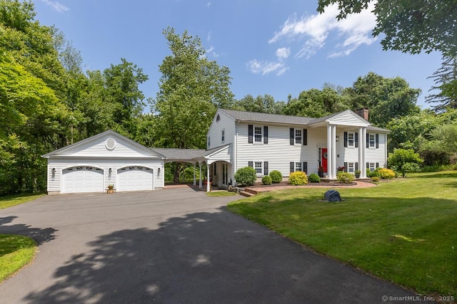 10 Laurel Grove Dr, Haddam, CT 06441 - raised ranch with a chimney, an attached garage, driveway, a front lawn, and view of scattered trees