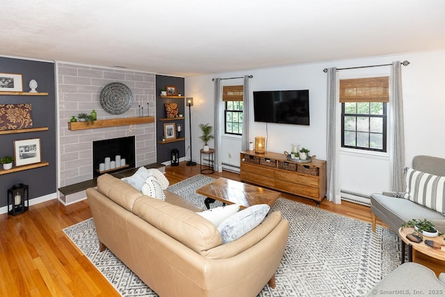 10 Laurel Grove Dr, Haddam, CT 06441 - living room featuring a baseboard radiator, wood finished floors, a large fireplace, and baseboard heating