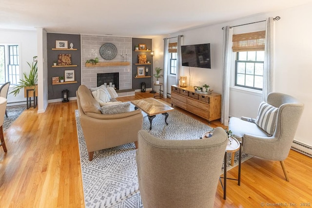 10 Laurel Grove Dr, Haddam, CT 06441 - living area featuring baseboard heating, light wood-type flooring, healthy amount of natural light, and a fireplace