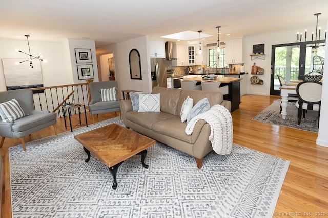 10 Laurel Grove Dr, Haddam, CT 06441 - living room featuring light wood-style flooring and a chandelier