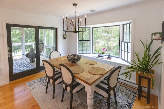 10 Laurel Grove Dr, Haddam, CT 06441 - dining room with a baseboard radiator, light wood-type flooring, plenty of natural light, a chandelier, and ornamental molding