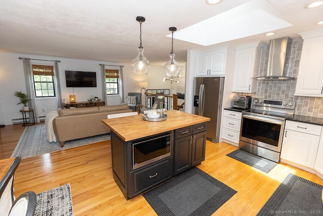 10 Laurel Grove Dr, Haddam, CT 06441 - kitchen with stainless steel appliances, wall chimney exhaust hood, butcher block counters, white cabinets, and tasteful backsplash