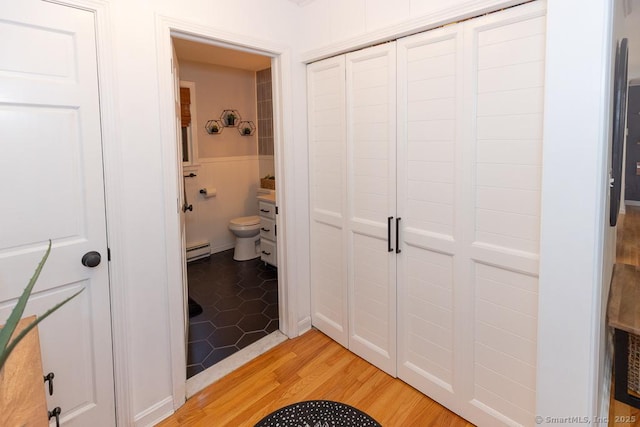 10 Laurel Grove Dr, Haddam, CT 06441 - bathroom featuring a baseboard heating unit, wainscoting, and wood finished floors